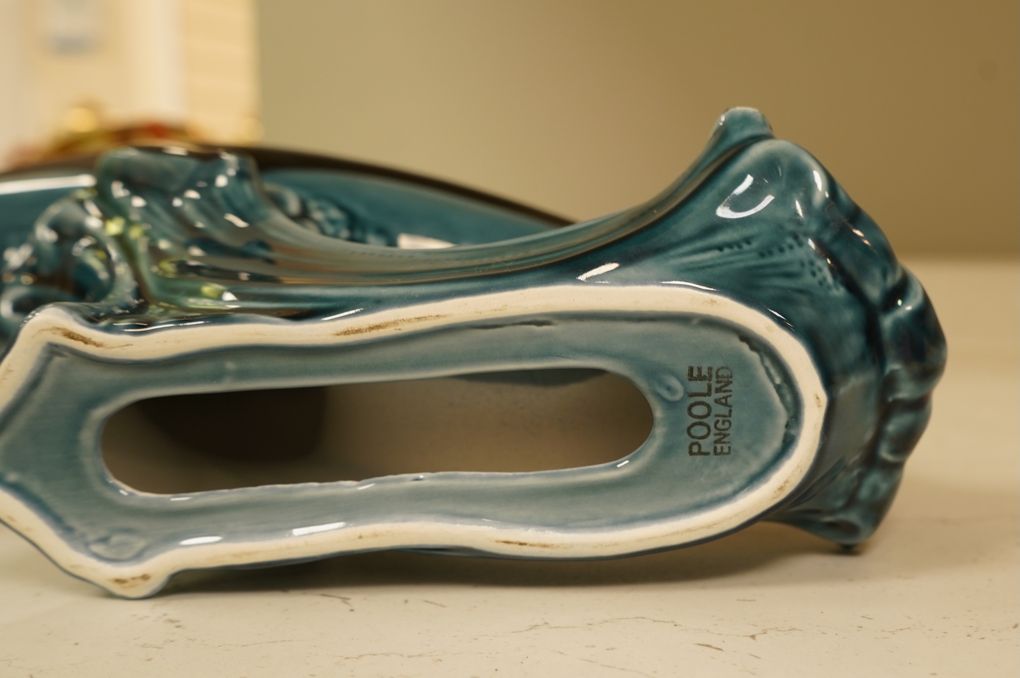 A Poole Pottery hors d’ouevres dish, a dolphin, a box and cover and a Torquay ware Brixham jar